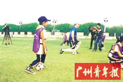 热刺足球俱乐部球员传授足球技能。