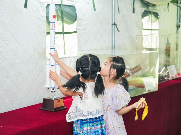 青少年好奇触摸中国航天火箭